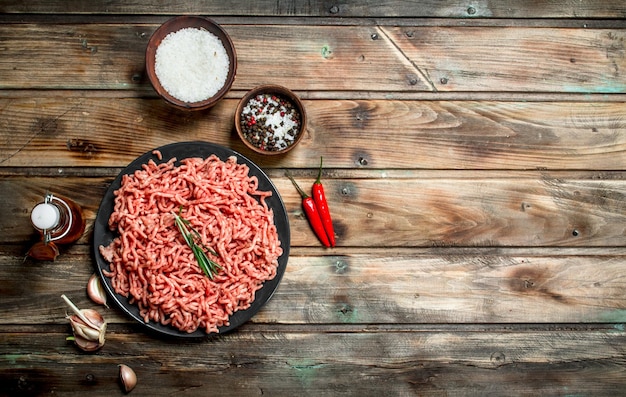 Raw minced meat in a plate with spices and herbs