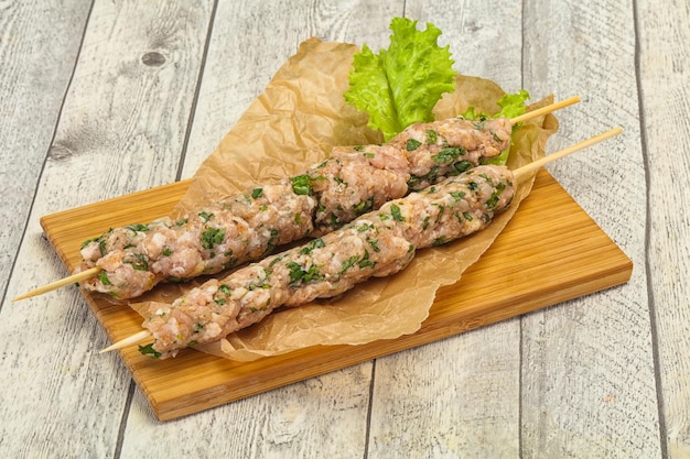 Raw minced pork skewer kebab for grill