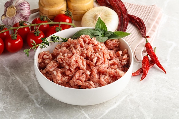 Raw minced pork uncooked meat in the bowl