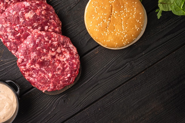 Raw Minced Steak Burgers from Beef Meat set, on black wooden table