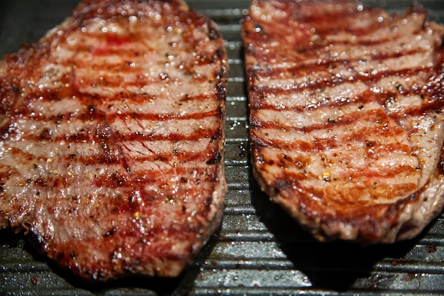 Raw minute steak of marbled beef in a grill pan