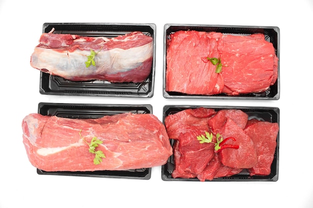 Raw mix beef steaks and thighs meat top view isolated on white background