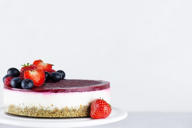 Raw mousse cake made from cauliflower pumpkin seeds and berries