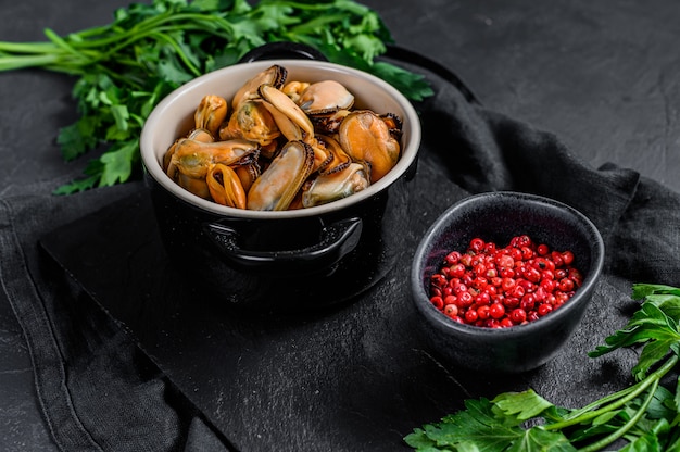 Raw mussel meat on a chopping Board with parsley. 