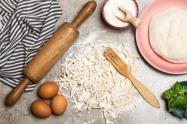 Raw noodles and ingredients on a marble table