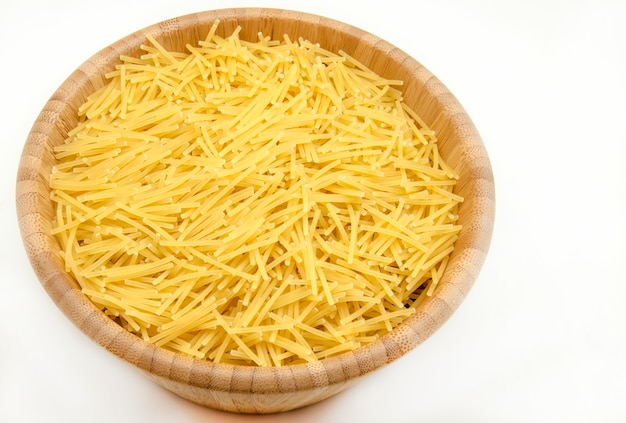 raw noodles in wooden bowl