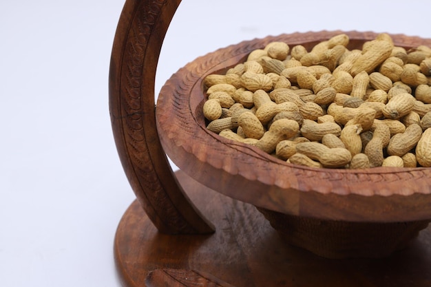 Raw Nuts in bowl on a plain background