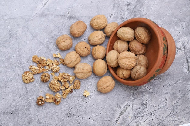 Raw Nuts in bowl on a plain background