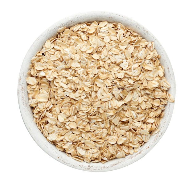 Photo raw oatmeal in a white wooden bowl on a white background