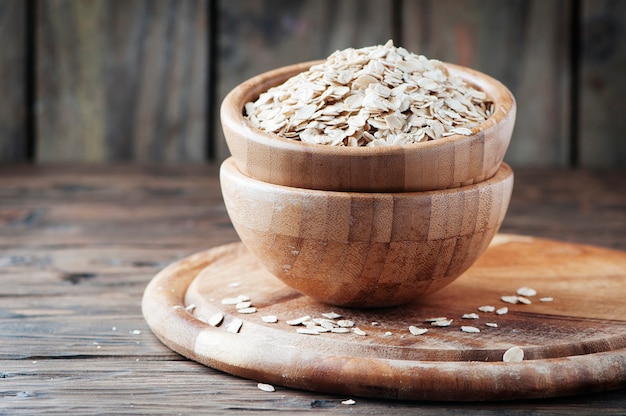 Raw oatmeal on the wooden table