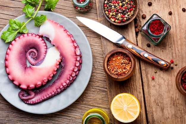 Raw octopus on wooden table