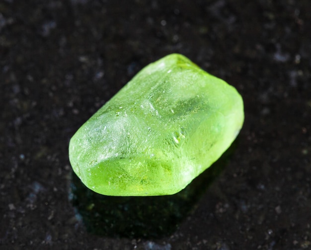 Raw Olivine Peridot Chrysolite crystal on black