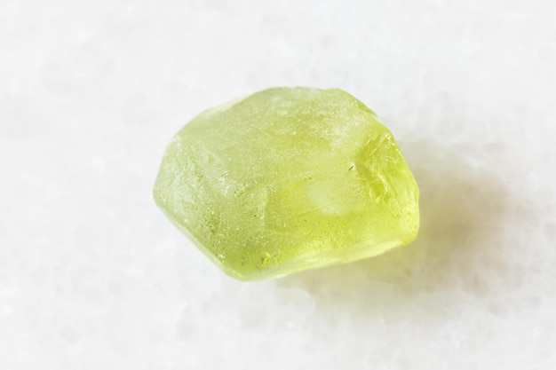 Raw Olivine Peridot Chrysolite crystal on white