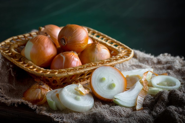 Raw onions in a composition on an old background