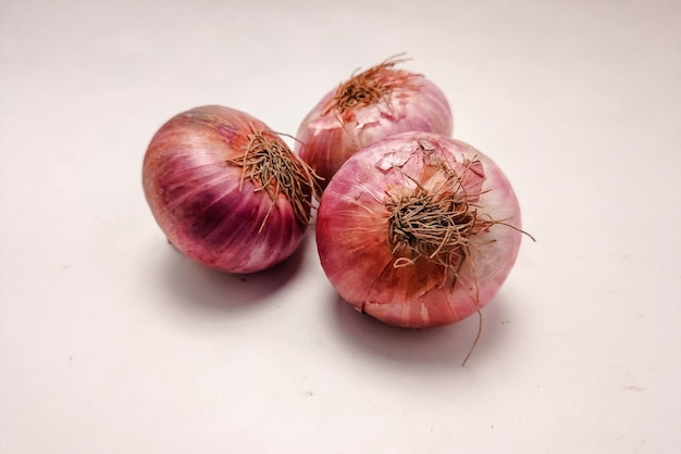 Raw onions on a white surface