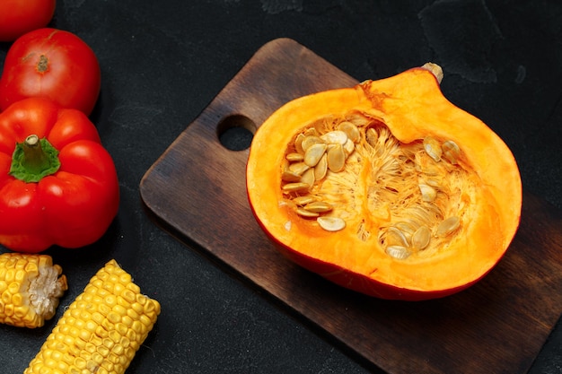 Raw orange pumpkin and wooden cutting board