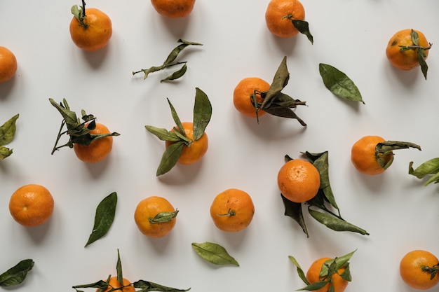 Raw oranges, tangerines with leaves pattern