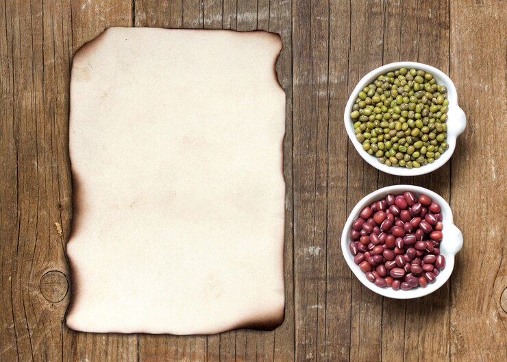 Photo raw organic azuki and mung beans in bowls top view on a wooden table with paper copy space
