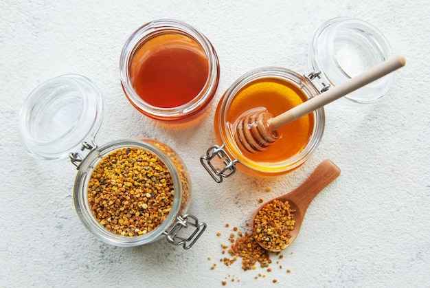 raw organic bee pollen and honey in jars
