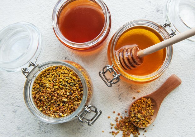 raw organic bee pollen and honey in jars