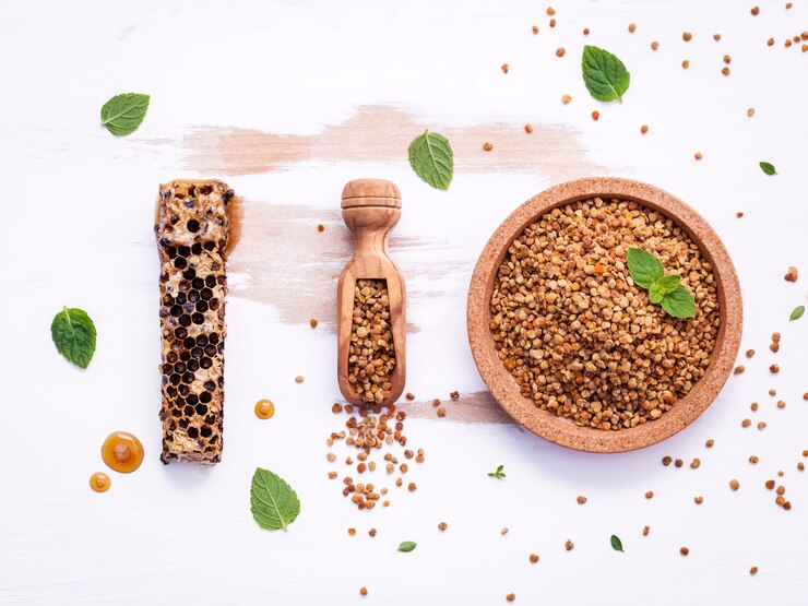 Raw organic bee pollen on shabby wooden board. 