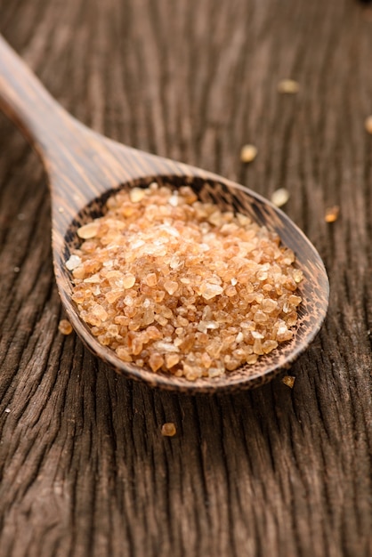 Raw Organic Cane Sugar in a wooden spoon