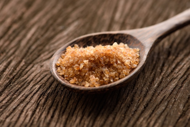 Raw Organic Cane Sugar in a wooden spoon