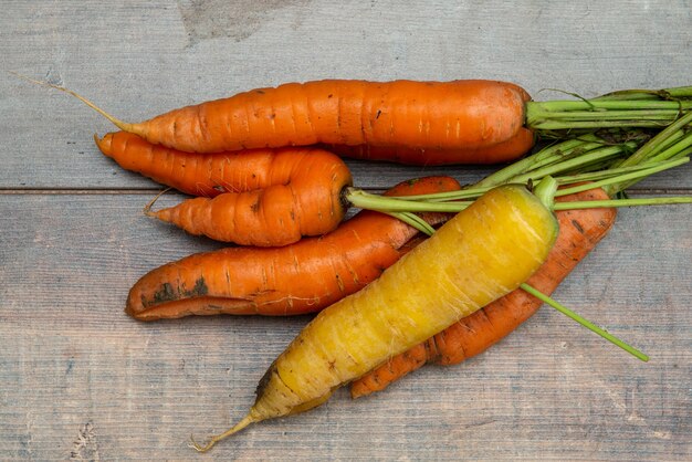 Raw organic carrots on the rustic wooden surface