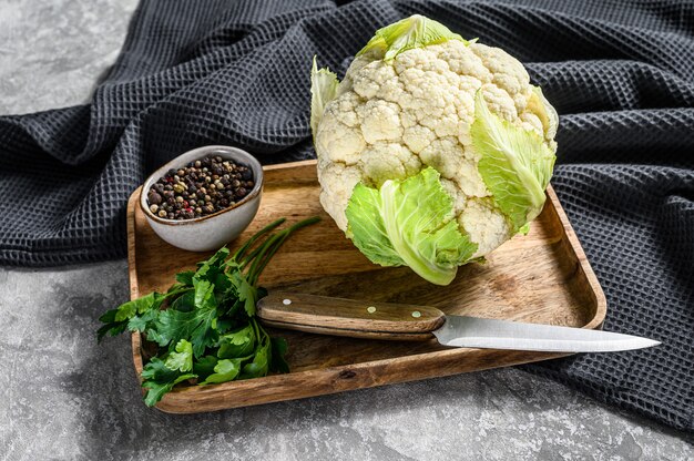 Raw organic cauliflower with leaves. top view