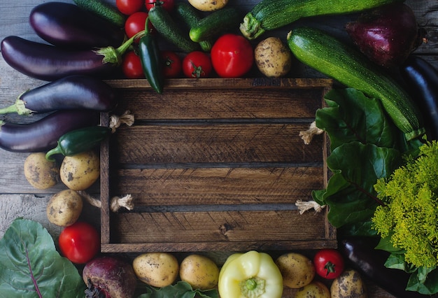 Raw organic fresh vegetables on wooden background