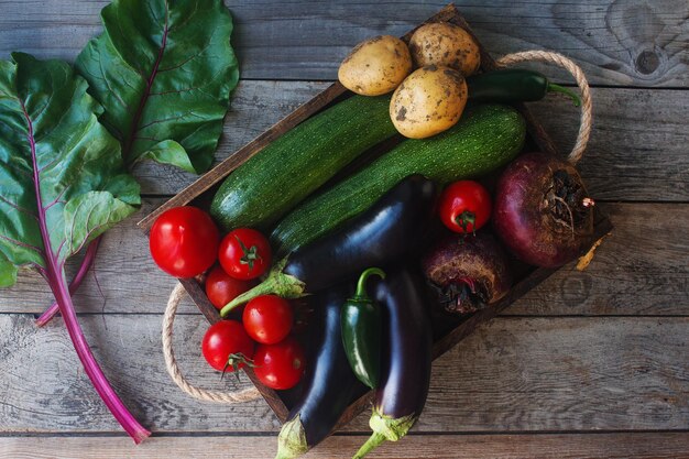 Raw organic fresh vegetables on wooden background