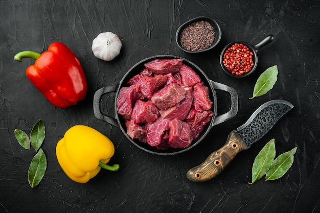 Raw organic meat  beef or lamb set with sweet bell pepper, in cast iron frying pan