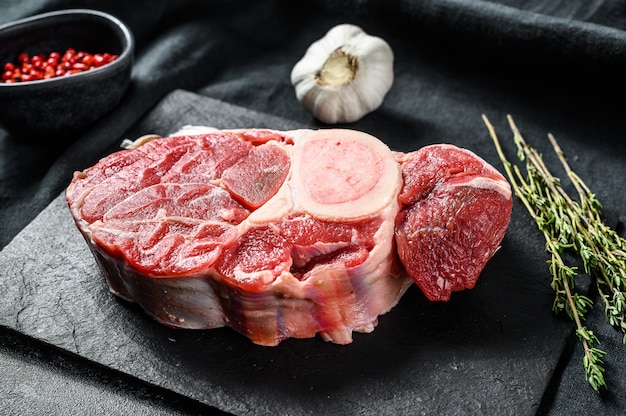 Raw Osso Buco veal meat cross-cut and seasonings