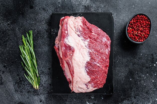 Raw outside Round roast beef meat cut on a marble board