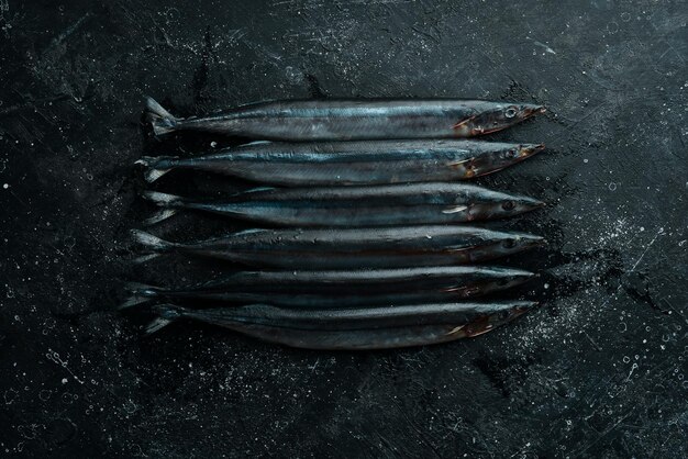 Raw Pacific fish Saury Seafood On a dark background