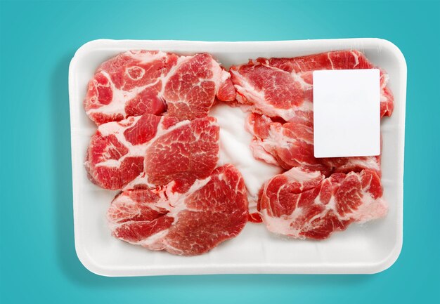 Raw packed meat on blue background, top view