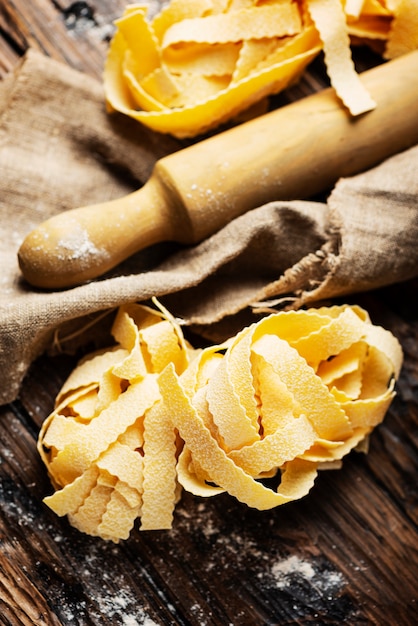 Raw Pappardelle on wooden table