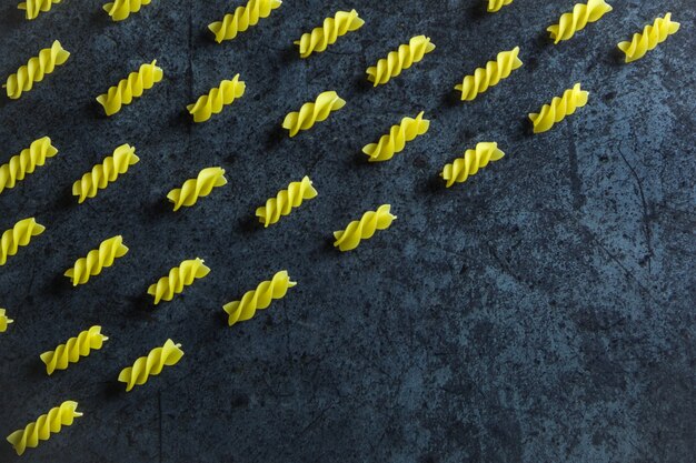 Raw pasta on blue, pattern