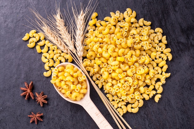 Raw pasta and ears of wheat