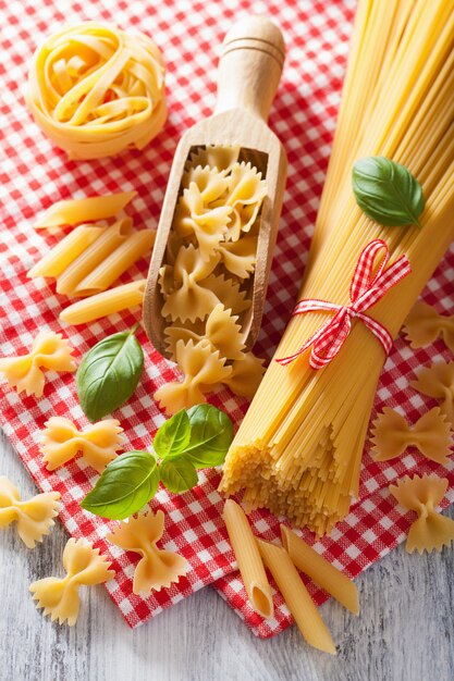 Raw pasta farfalle spaghetti penne tagliatelle. italian cuisine