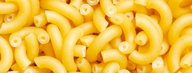 Raw pasta. Food background. An ingredient for traditional Italian food. Closeup