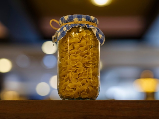 Raw pasta in glass jar