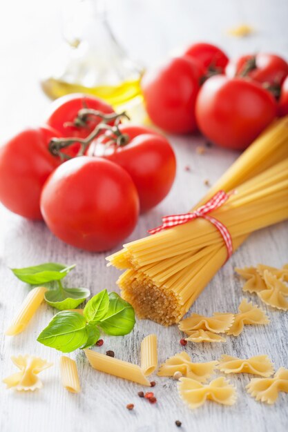 Raw pasta olive oil tomatoes. italian cuisine