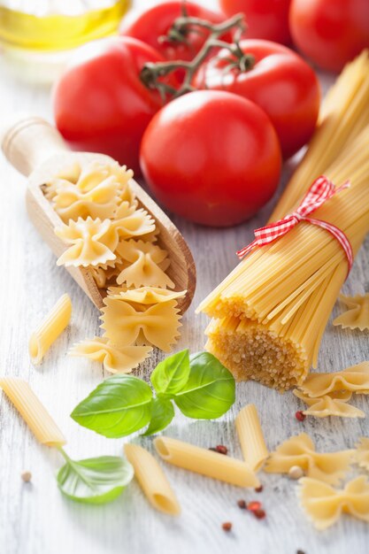 Raw pasta olive oil tomatoes. italian cuisine