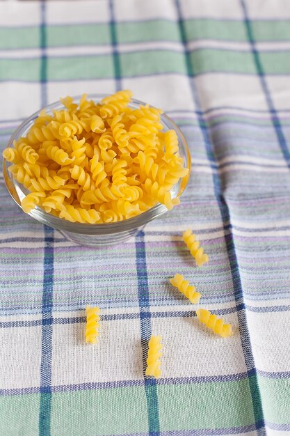 Raw pasta set background with many different sorts of pasta and farfalle closeup