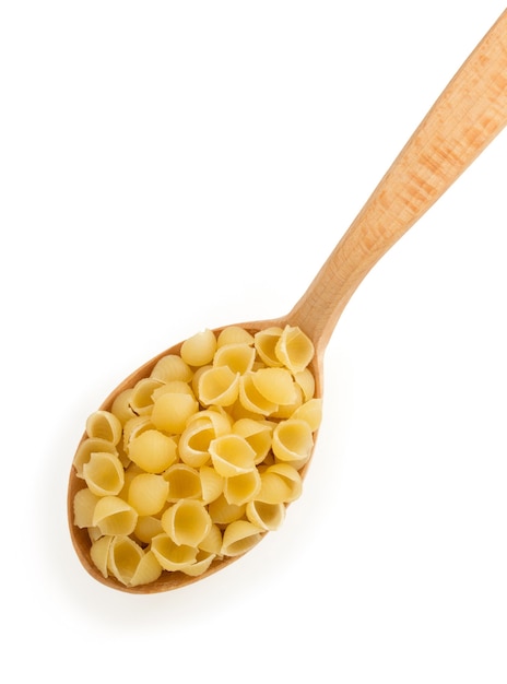 Raw pasta in spoon isolated on white