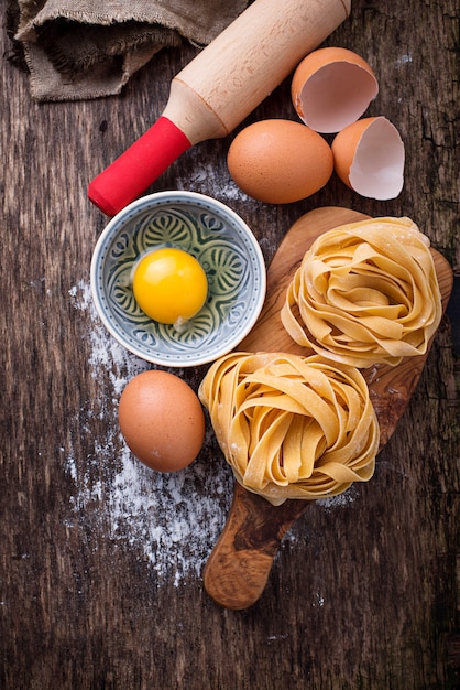 Raw pasta tagliatelle and eggs