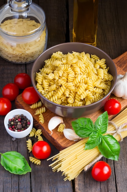 Raw pasta with cherry tomatoes and ingredients