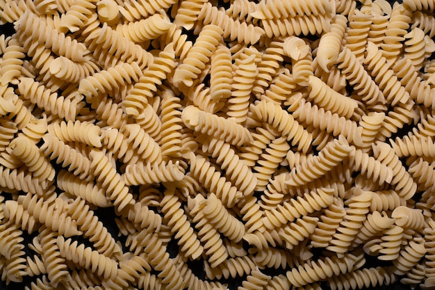 raw pasta with shapes on the table scattered with white light