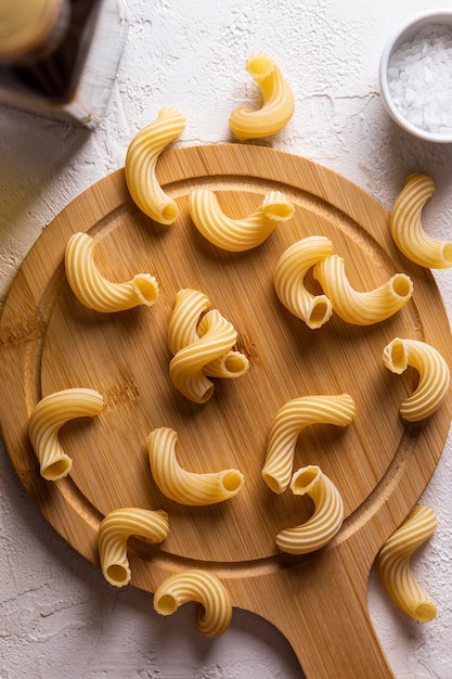 Raw pasta on a wooden board